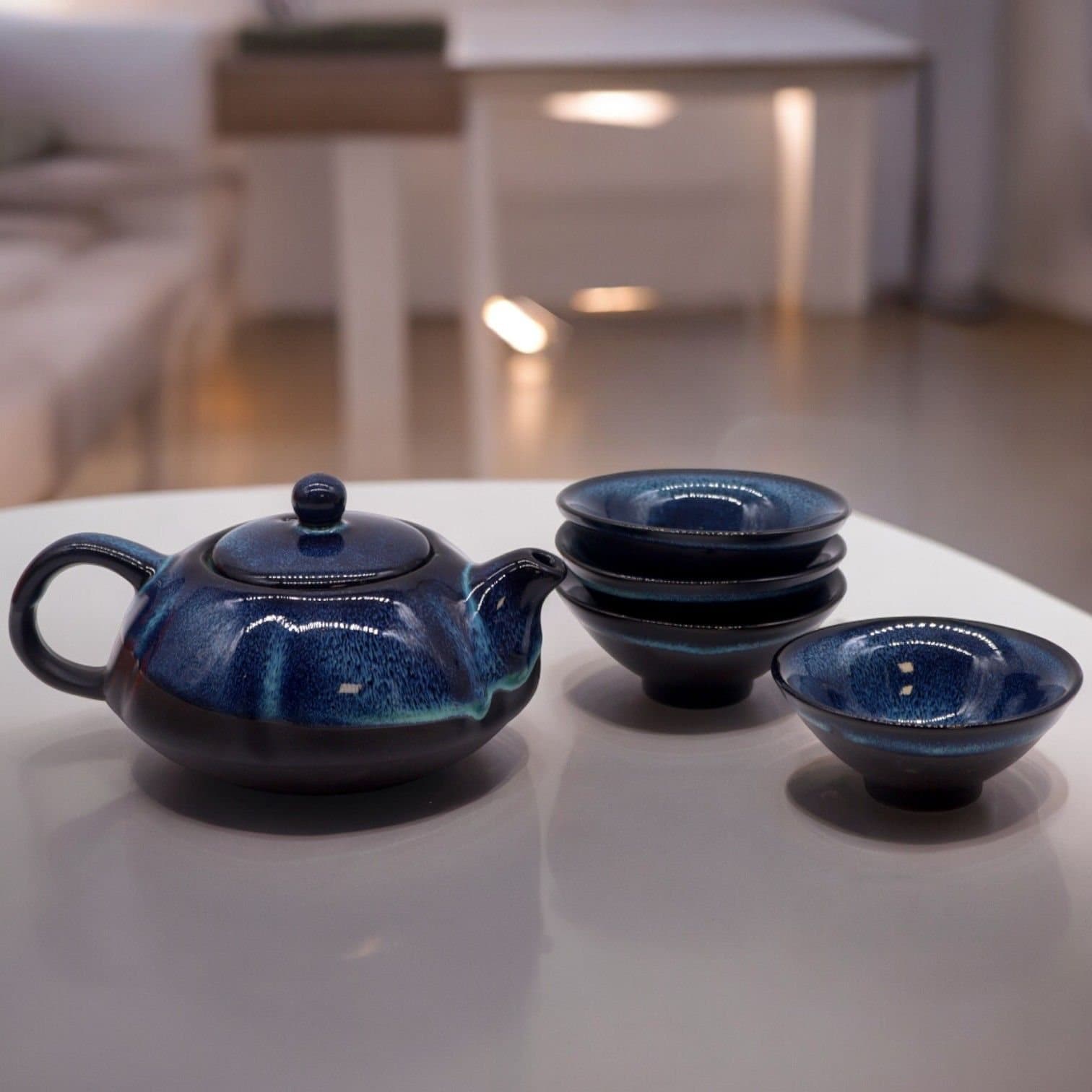 Blue glazed teapot with four cups