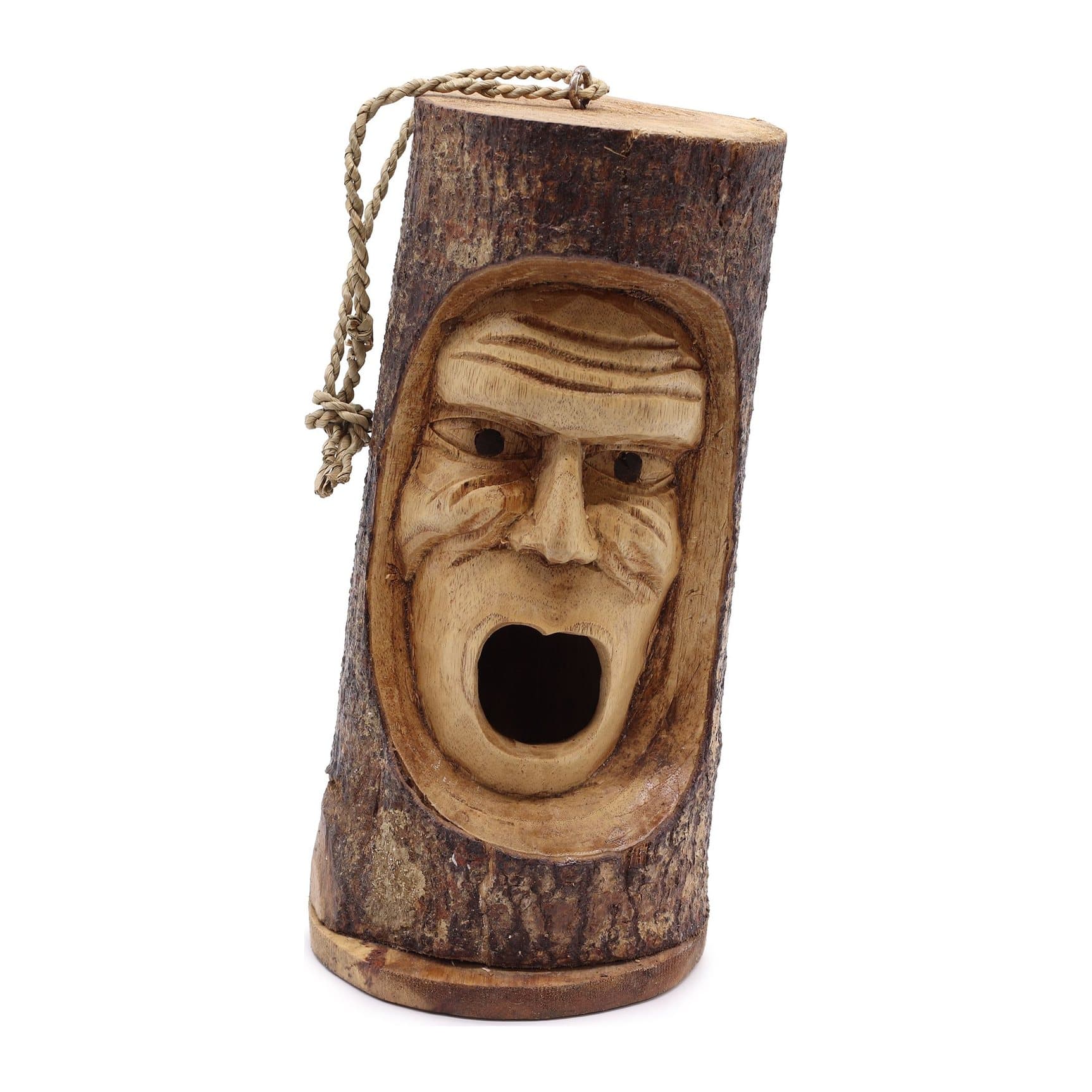 Carved tree trunk bird house with a grumpy face