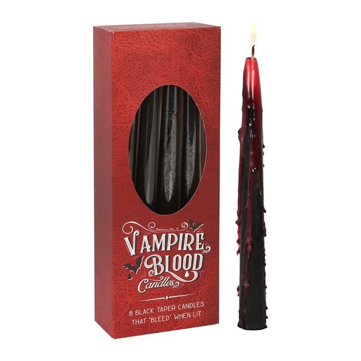 Black taper candles bleeding red wax