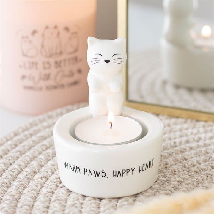 Ceramic cat tealight holder with Warm Paws text