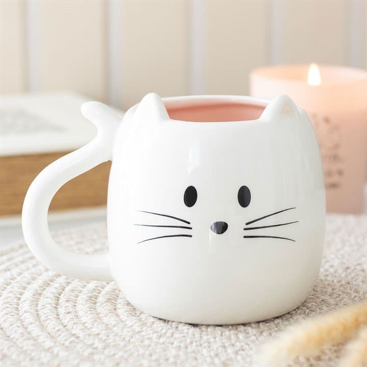 White ceramic mug shaped like a happy cat with perky ears and a whiskered face