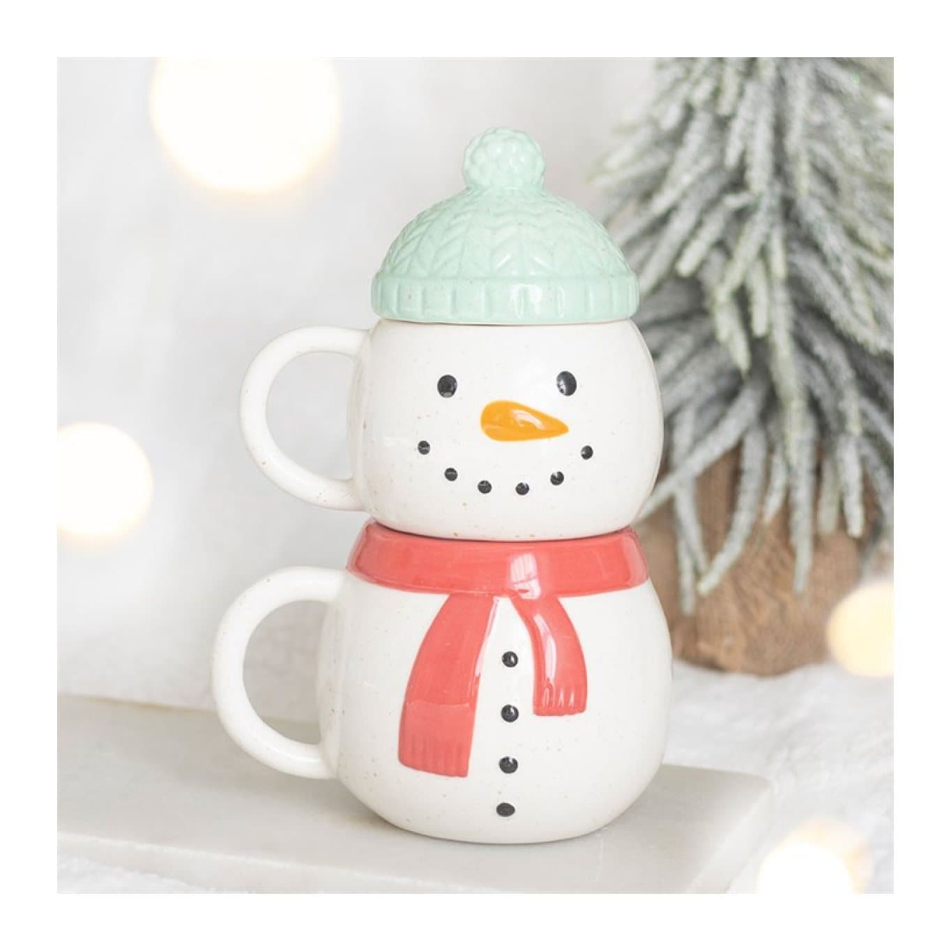 Two ceramic snowman Christmas mugs stacked together
