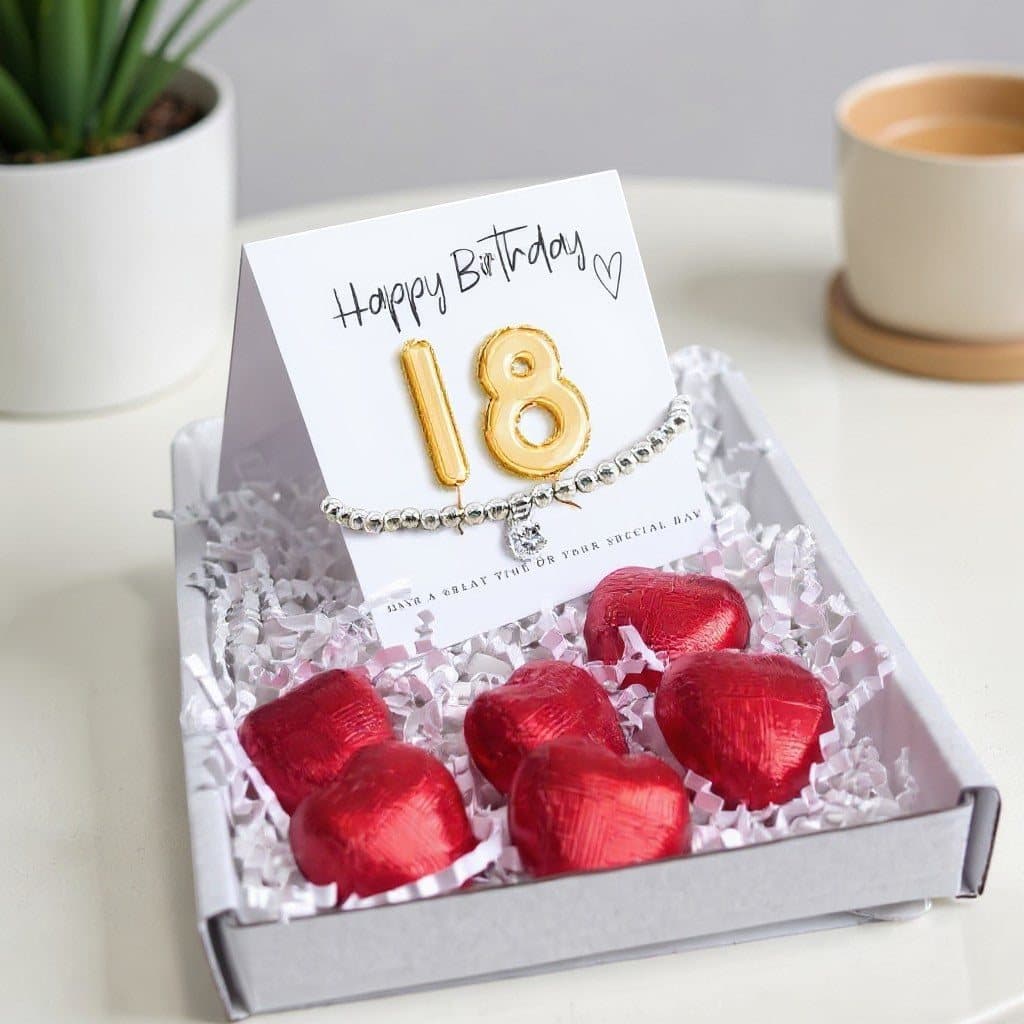 18th birthday gift box with a bracelet, gold card and chocolate hearts