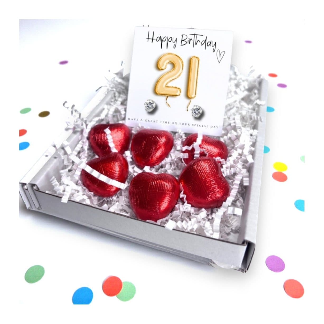 Cubic zirconia stud earrings on a gold balloons message card with milk chocolate hearts
