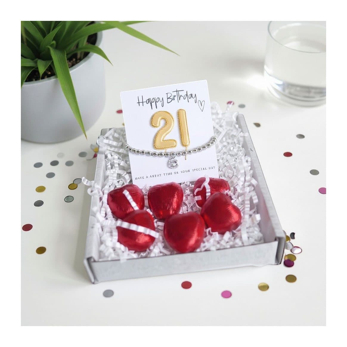 21st birthday gift box with a bracelet, chocolate hearts and a gold balloon card