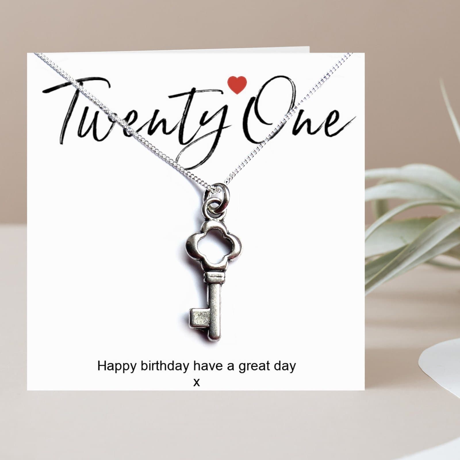 Silver key charm necklace with a 21st birthday message card