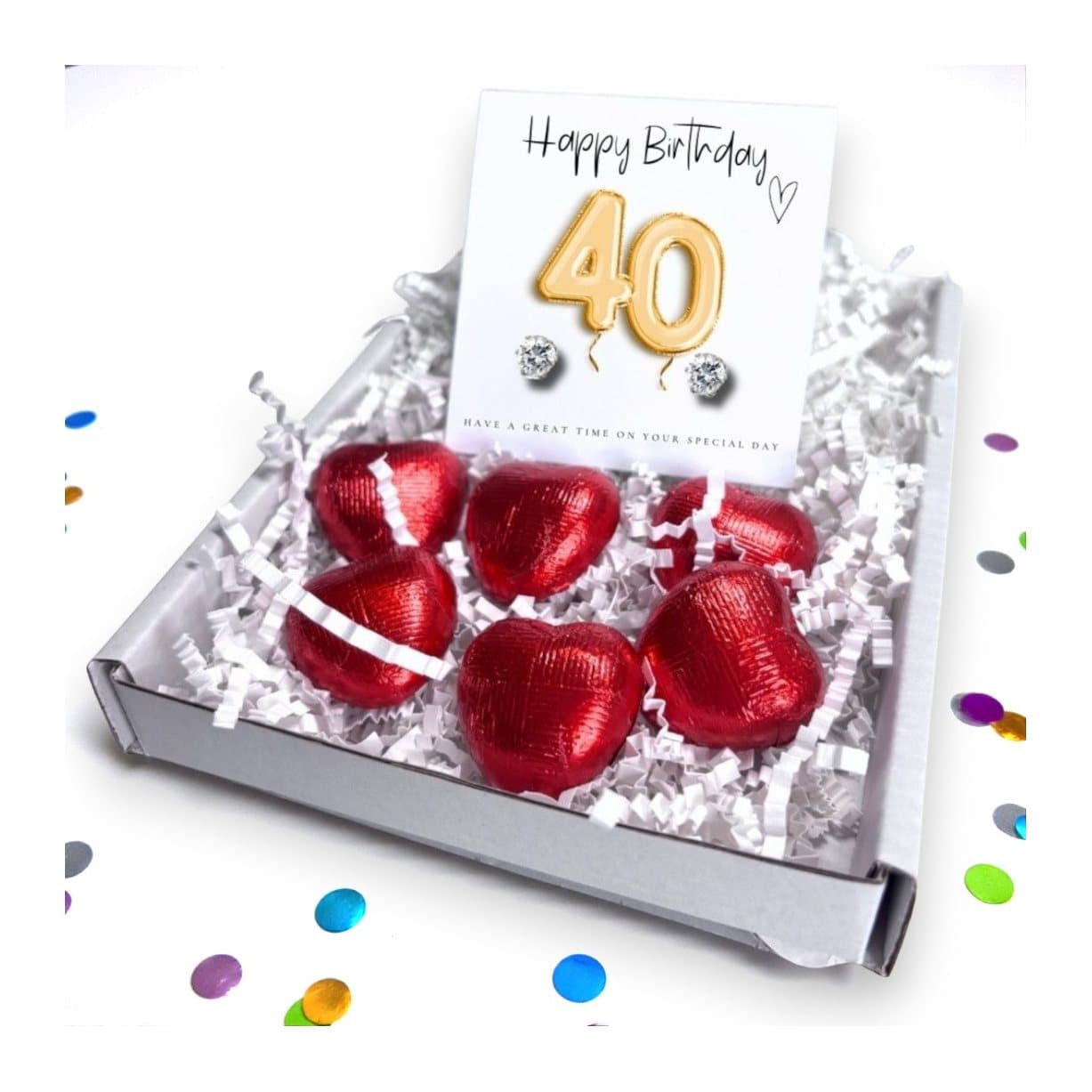 Stud earrings, red chocolate hearts and a gold balloons message card