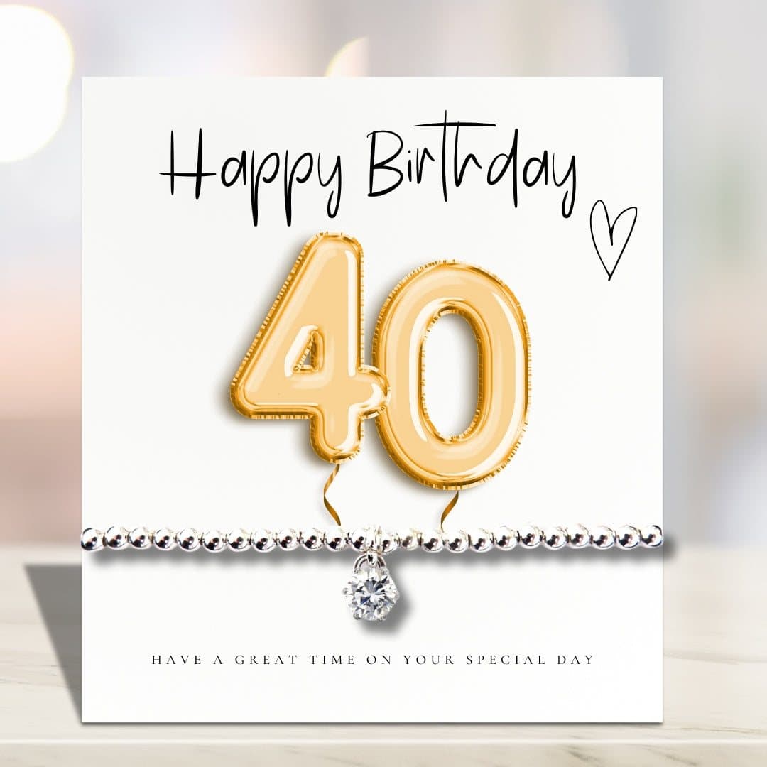 Silver stretch bracelet with a cubic zirconia charm and a gold balloons card