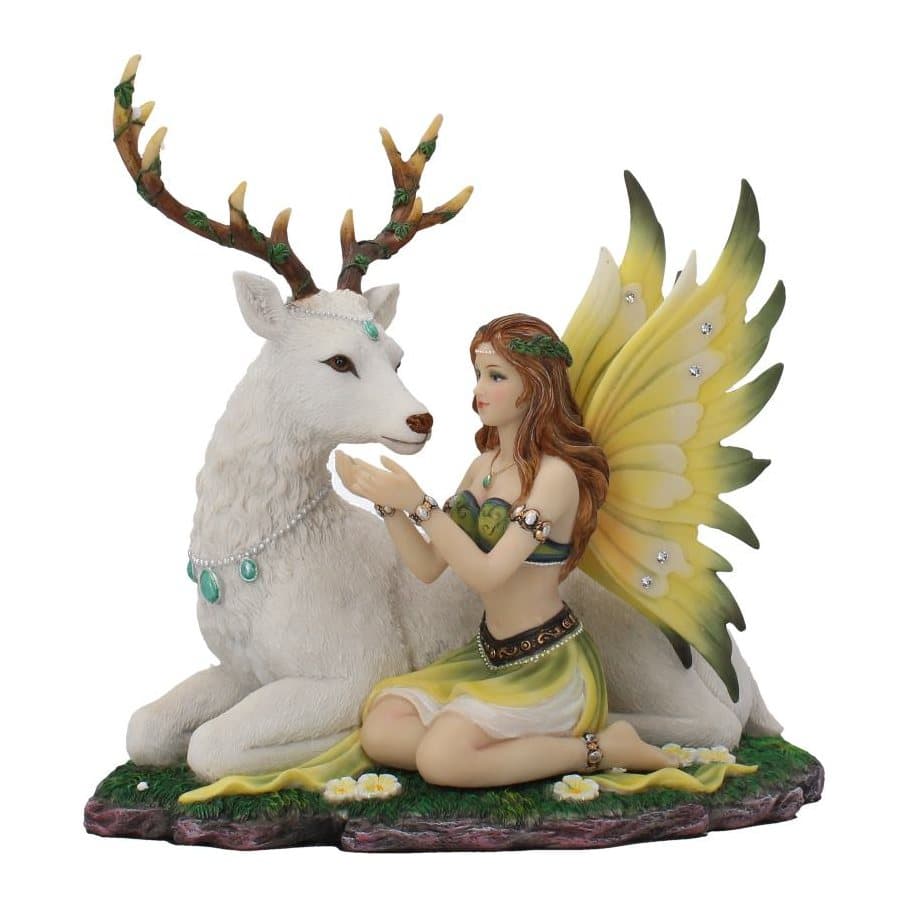 Auburn-haired fairy and white stag figurine in a flowered meadow