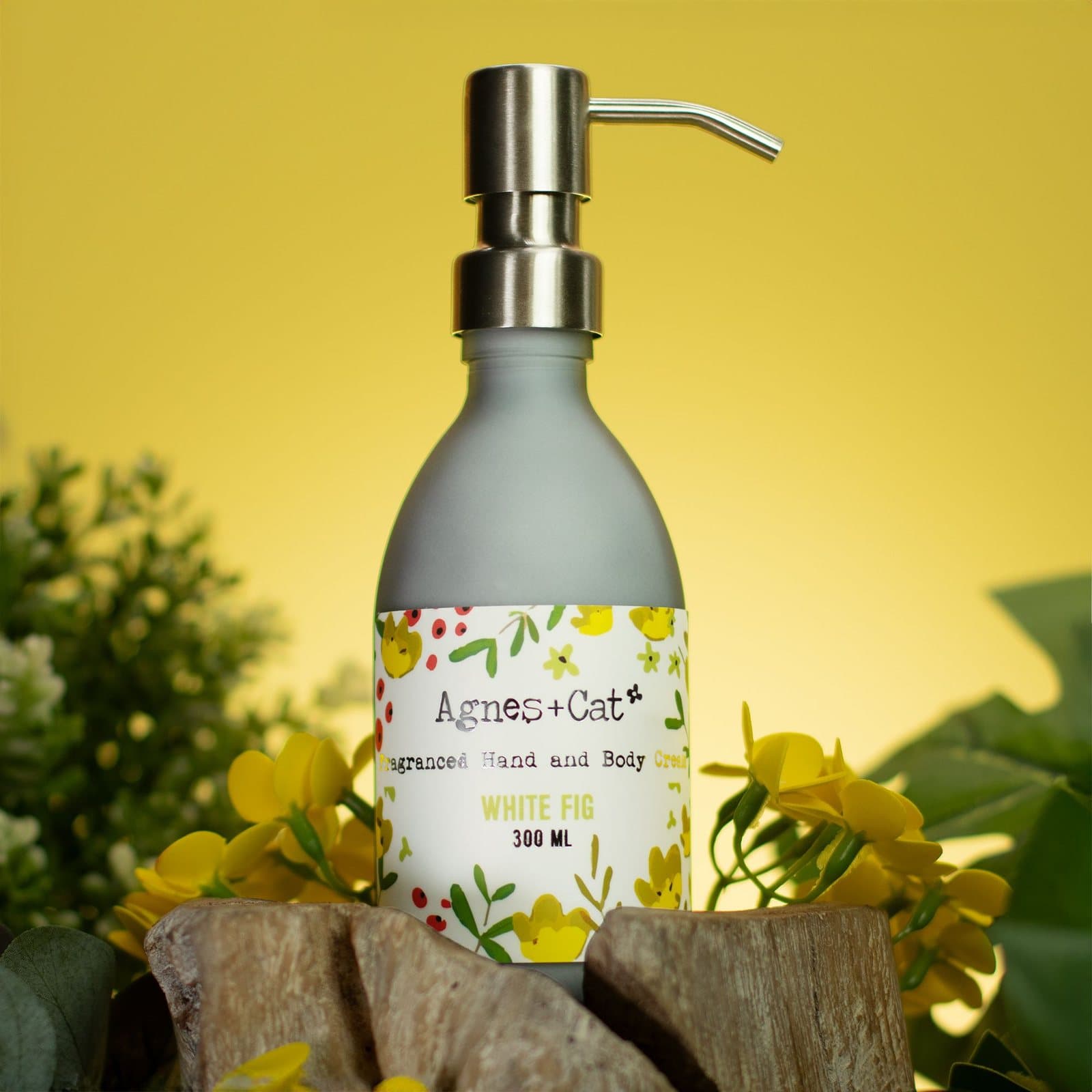 Frosted grey glass bottle of White Fig hand and body cream with a metal pump