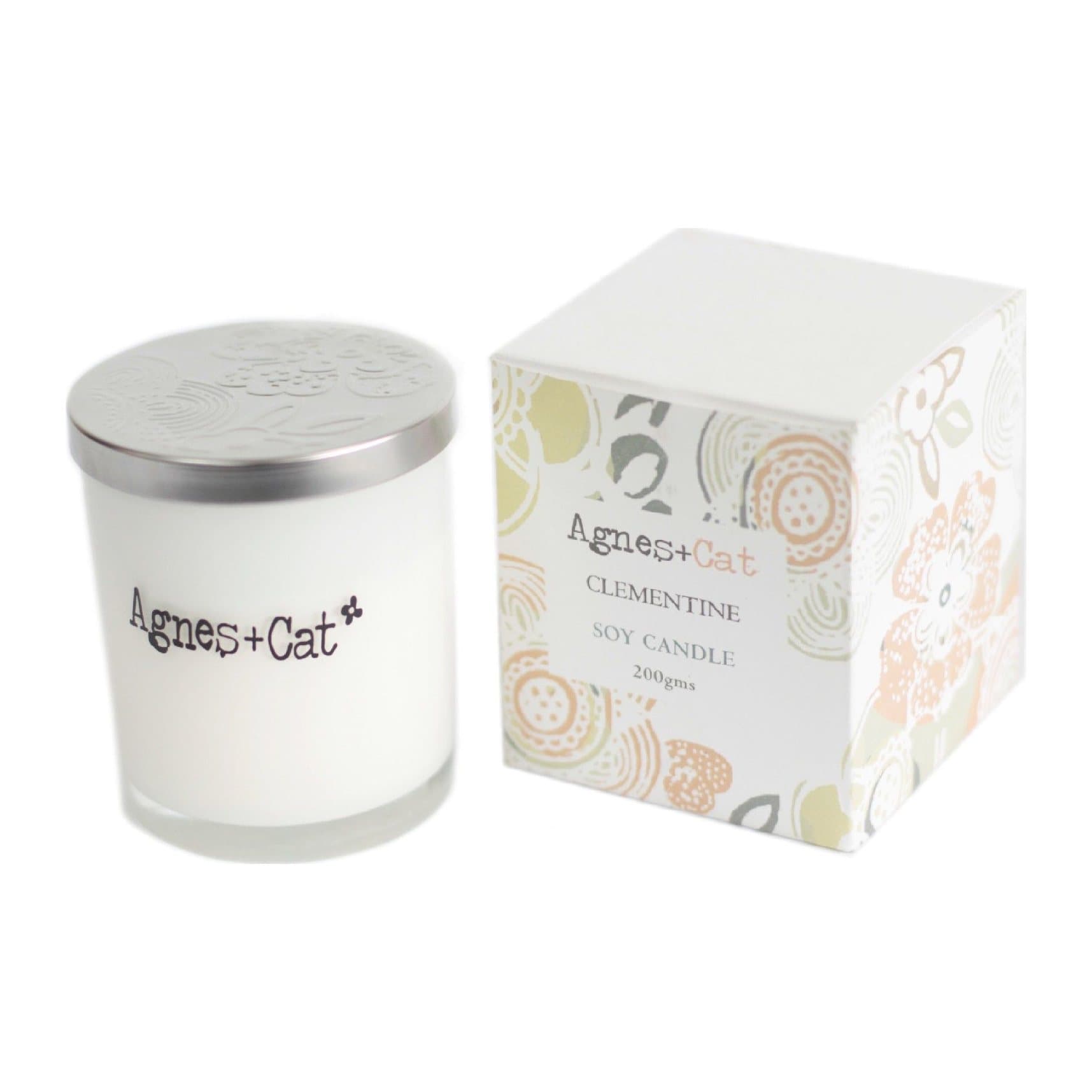 Frosted white glass votive candle with an embossed silver lid