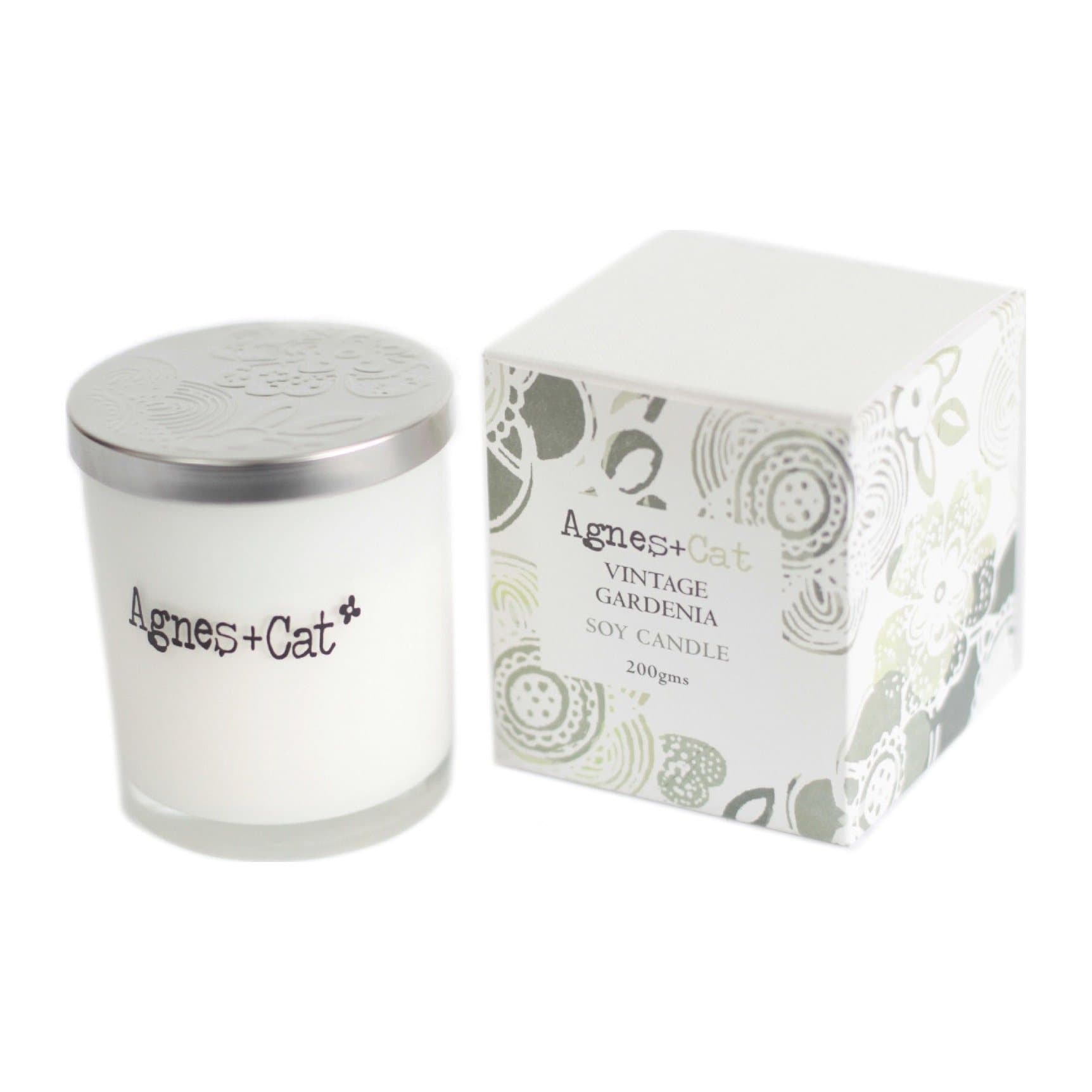 White glass votive candle with an embossed silver lid