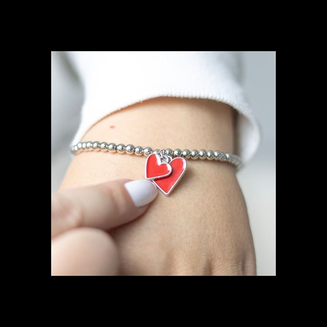 Beaded bracelet with a red enamel heart charm