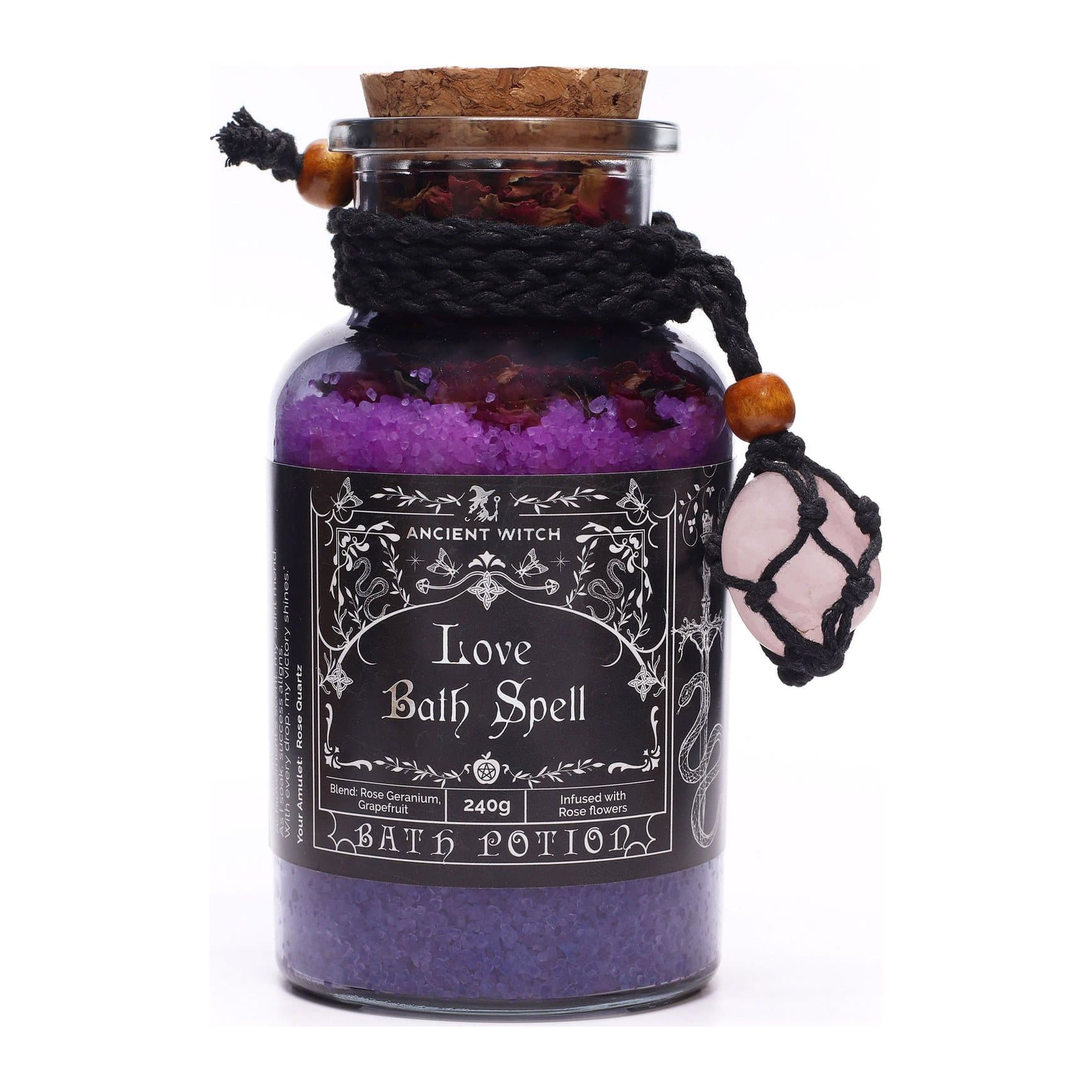 Glass bottle of rose quartz bath potion with a cork lid and rose quartz stone necklace