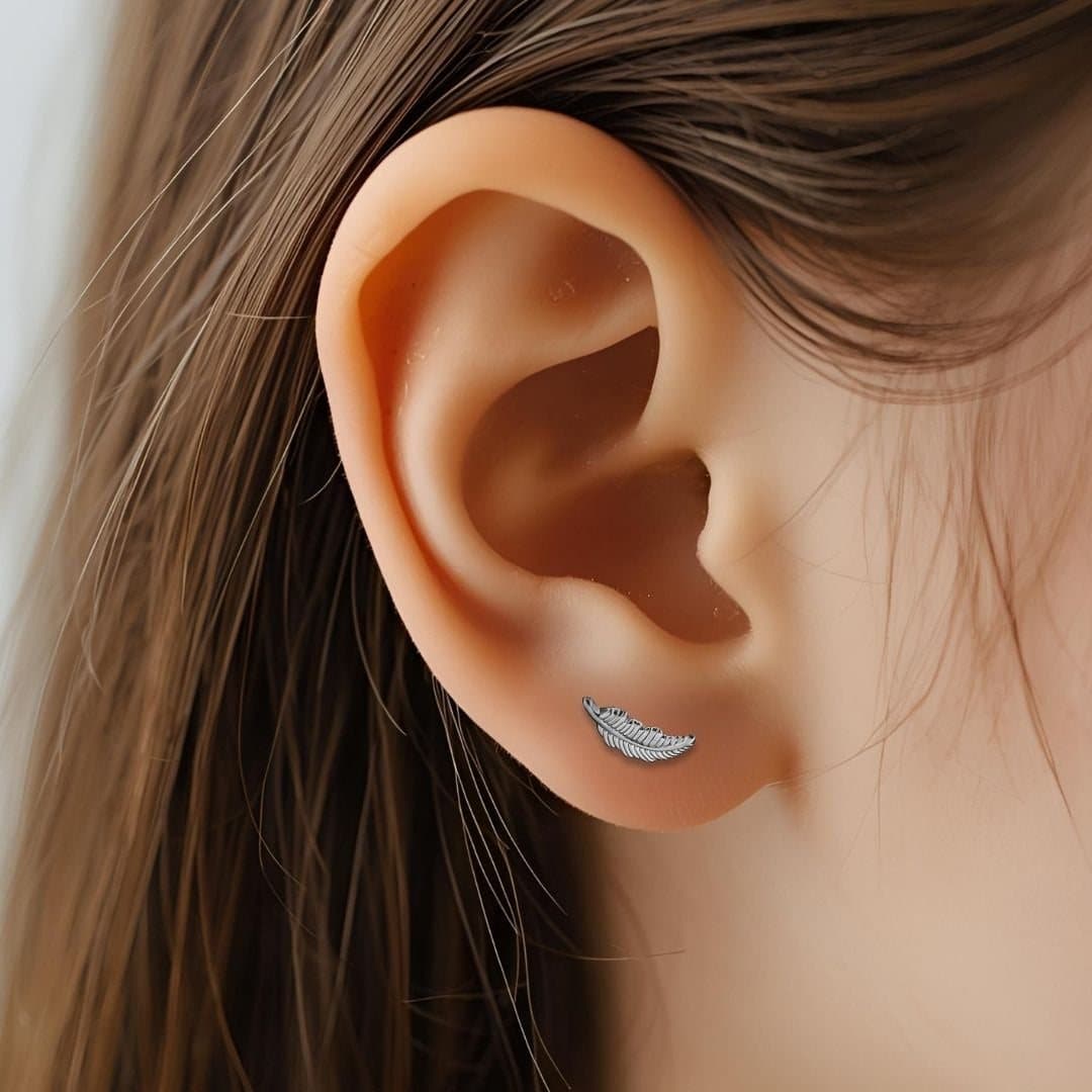 Silver stud earrings with an angel feather design