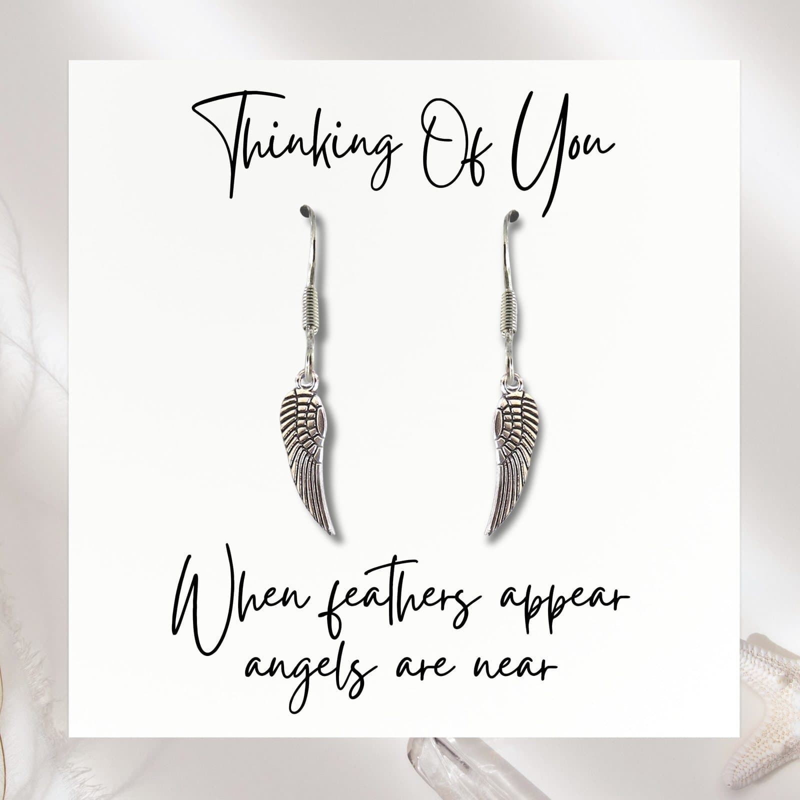 Silver angel feather earrings with an angel wing charm and a message card