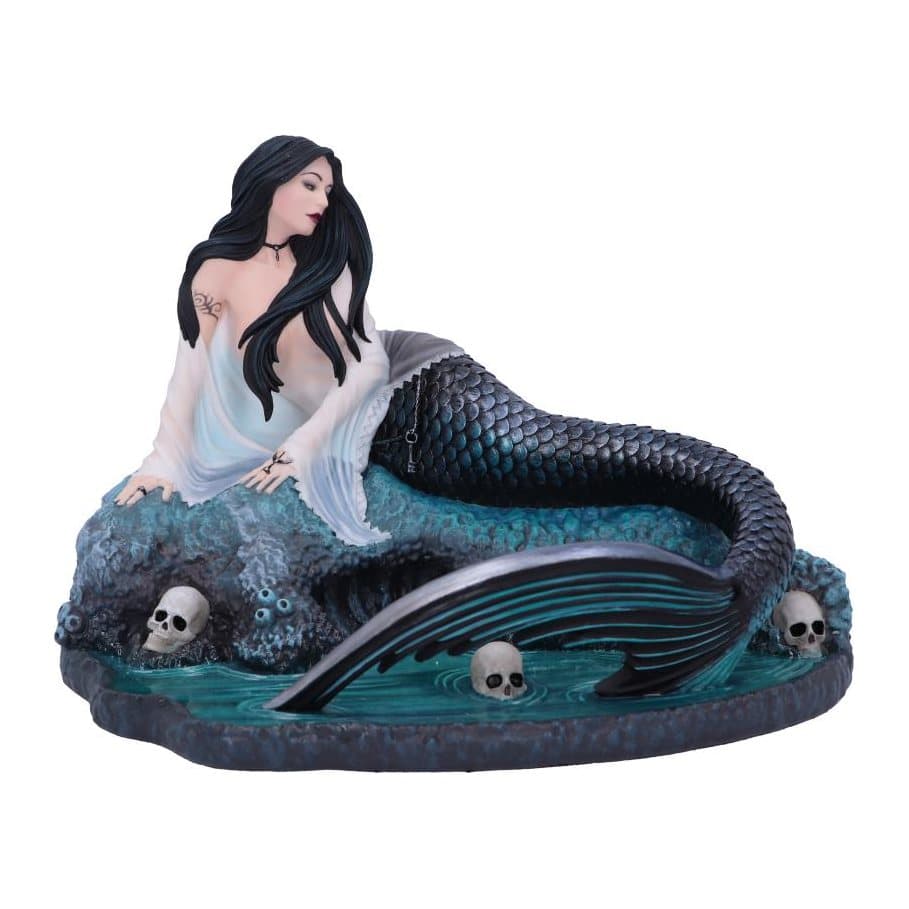 Resin siren figurine sitting on a rock with her tail in water among skulls