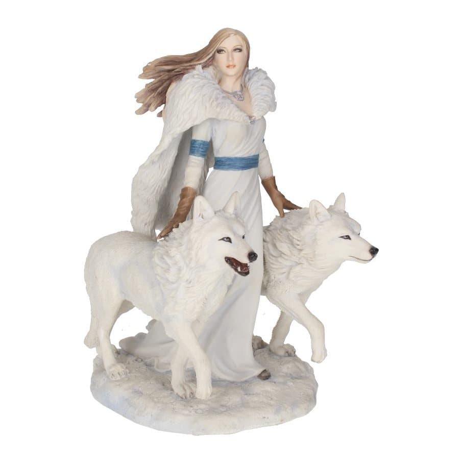 Figurine of a woman in white between two white wolves on snowy ground
