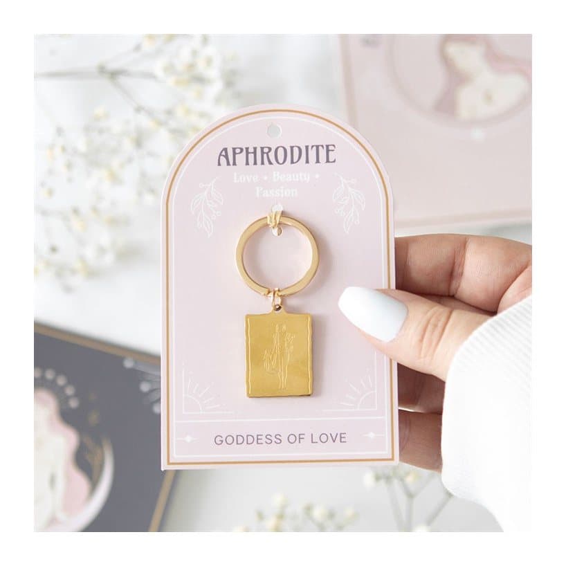 Aphrodite goddess talisman keyring with gold-toned pendant on a backing card