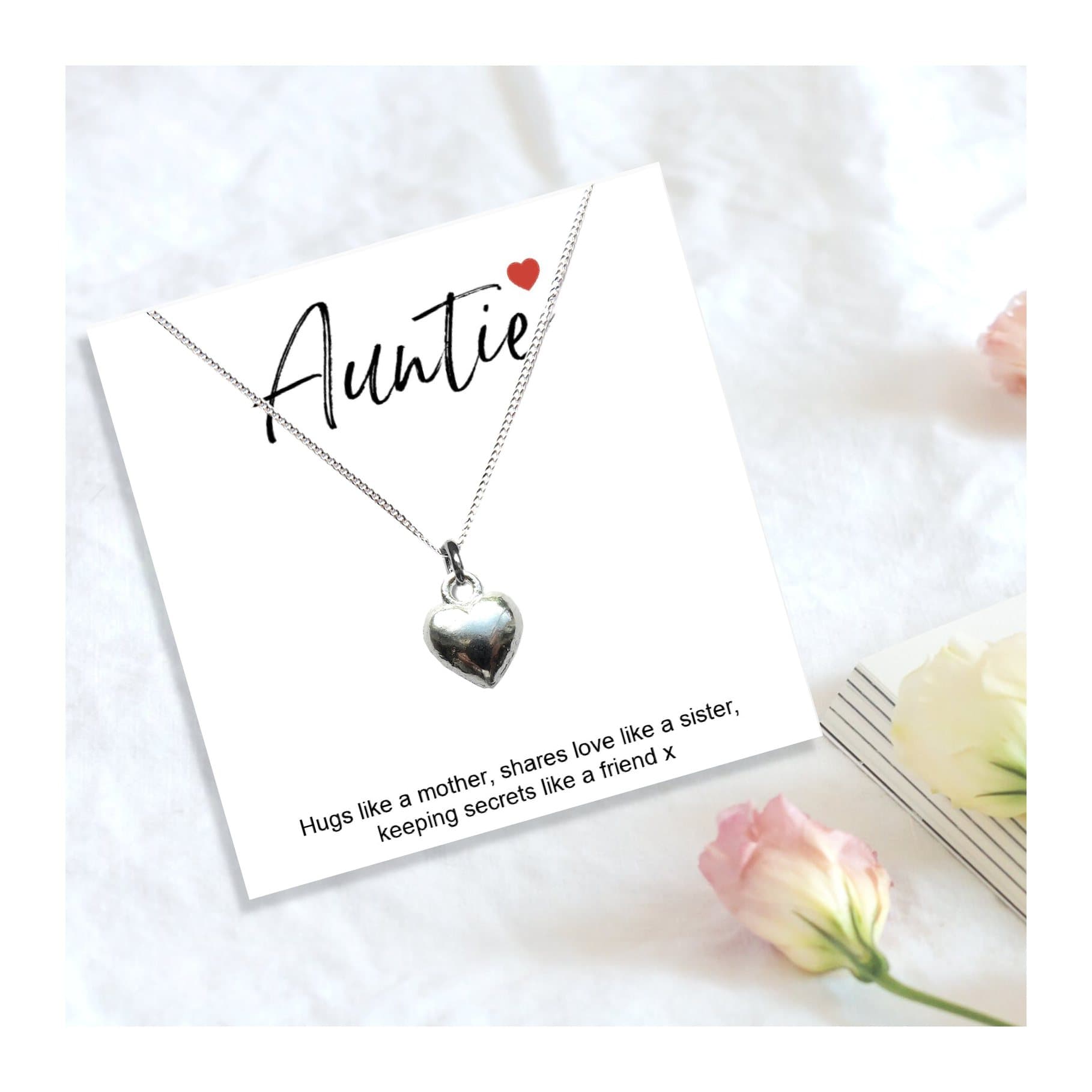 Heart necklace on a quote card: Auntie Hugs like a mother, share loves like a sister