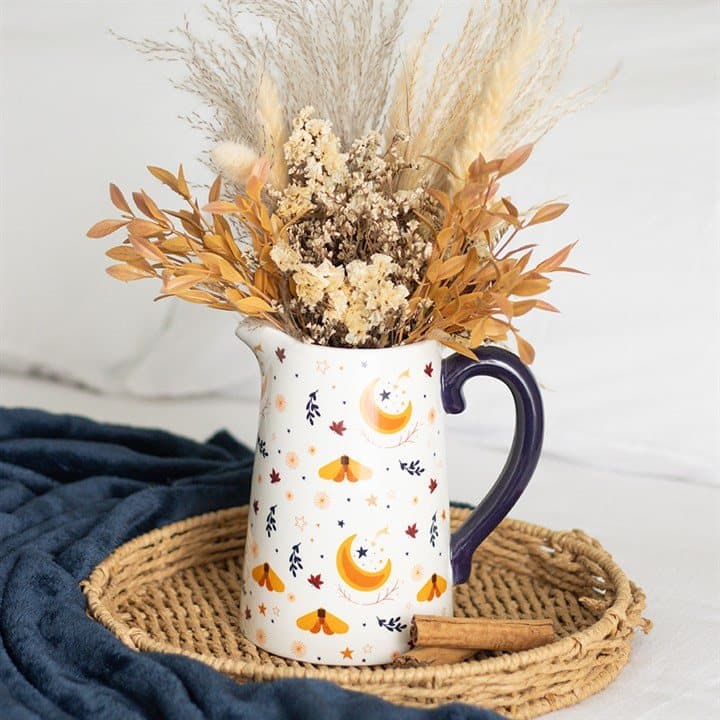 Ivory ceramic flower jug with a harvest moon design, leaves and golden accents