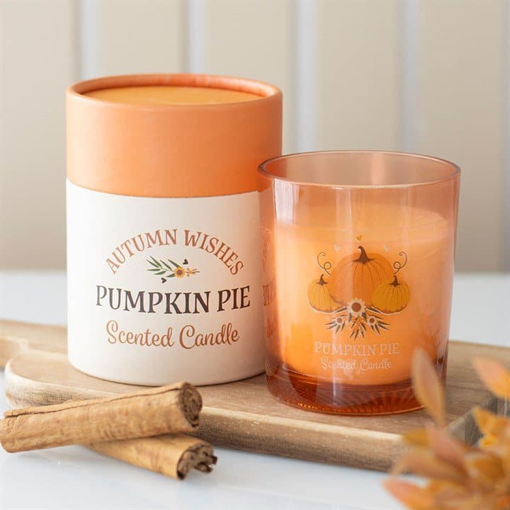 Pumpkin pie candle in a glass holder with a pumpkin design