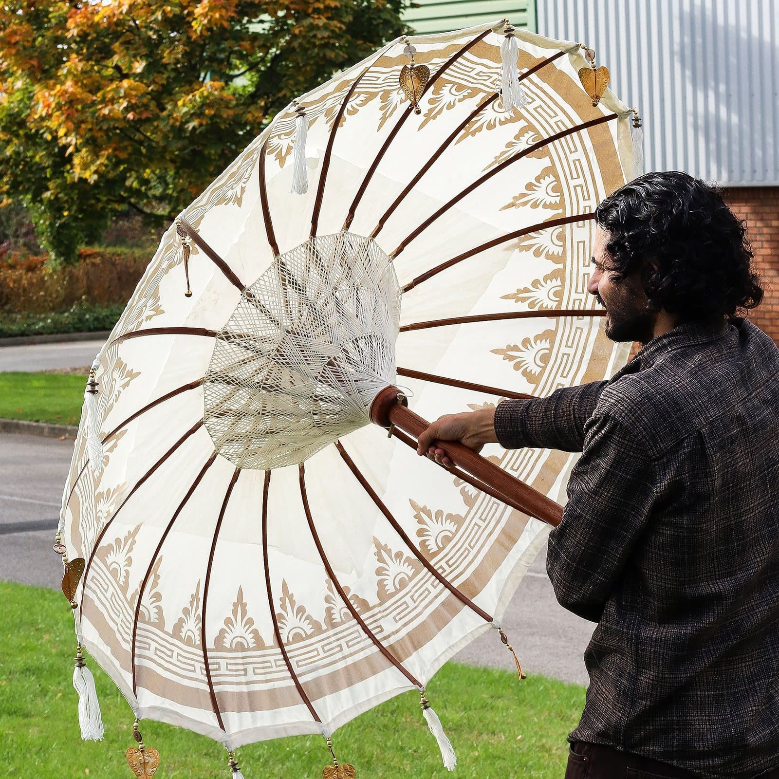 Natural canvas Bali patio parasol with tassels and golden motifs