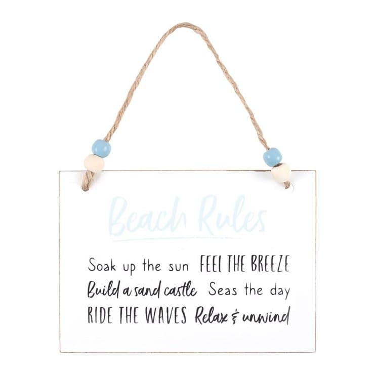 White wooden hanging sign with the beach rules text and a twine hanger