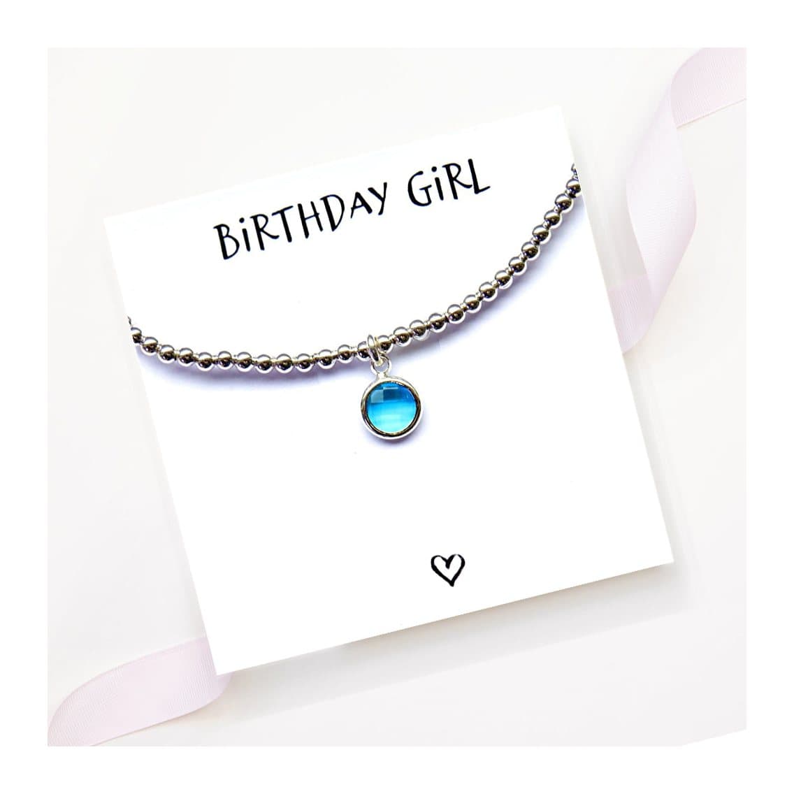 Birthstone charm bracelet with a coloured glass charm and a message card