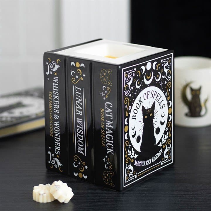 Ceramic oil burner and wax warmer shaped like stacked spell books with black cats