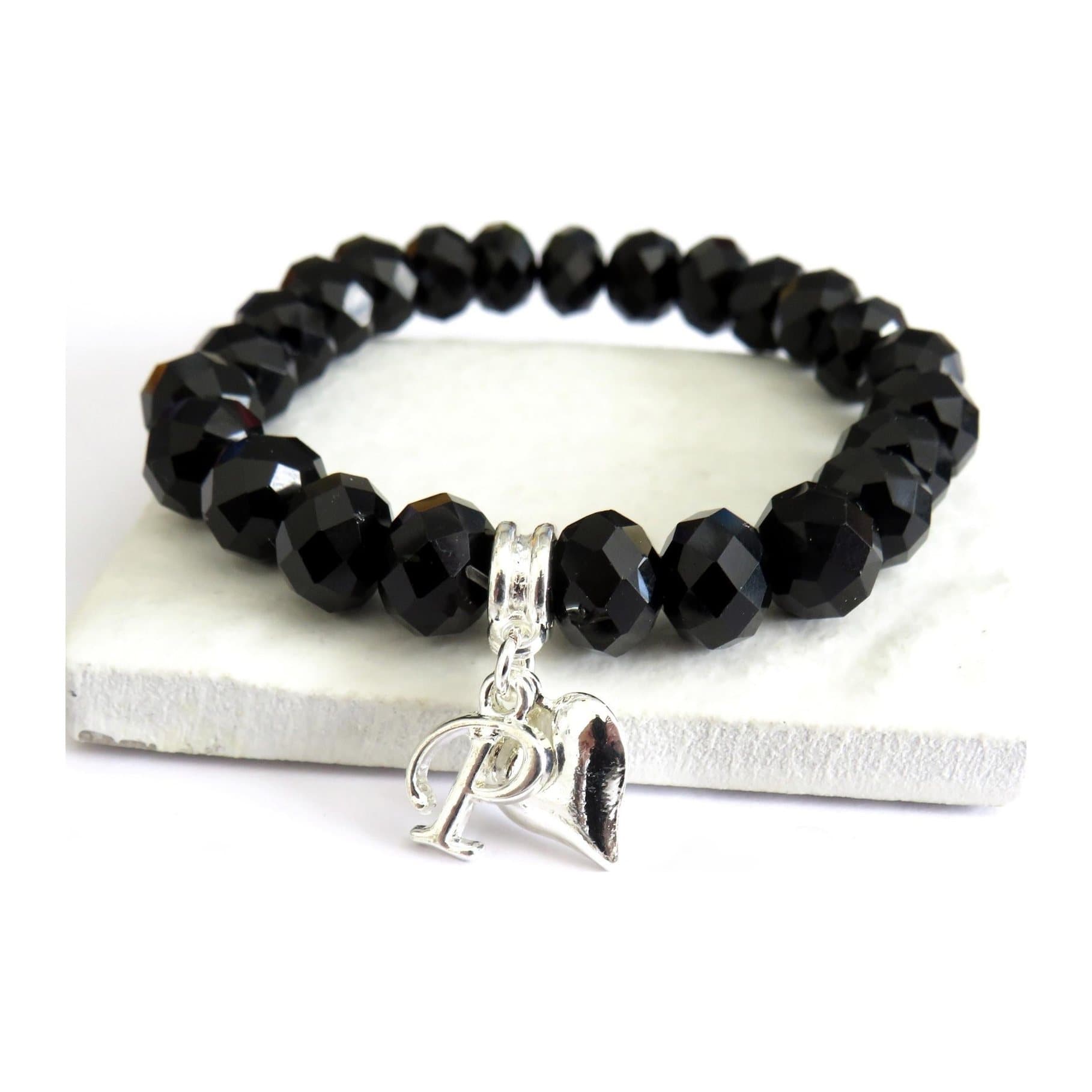 Black crystal beaded bracelet with an initial charm and silver plated heart charm