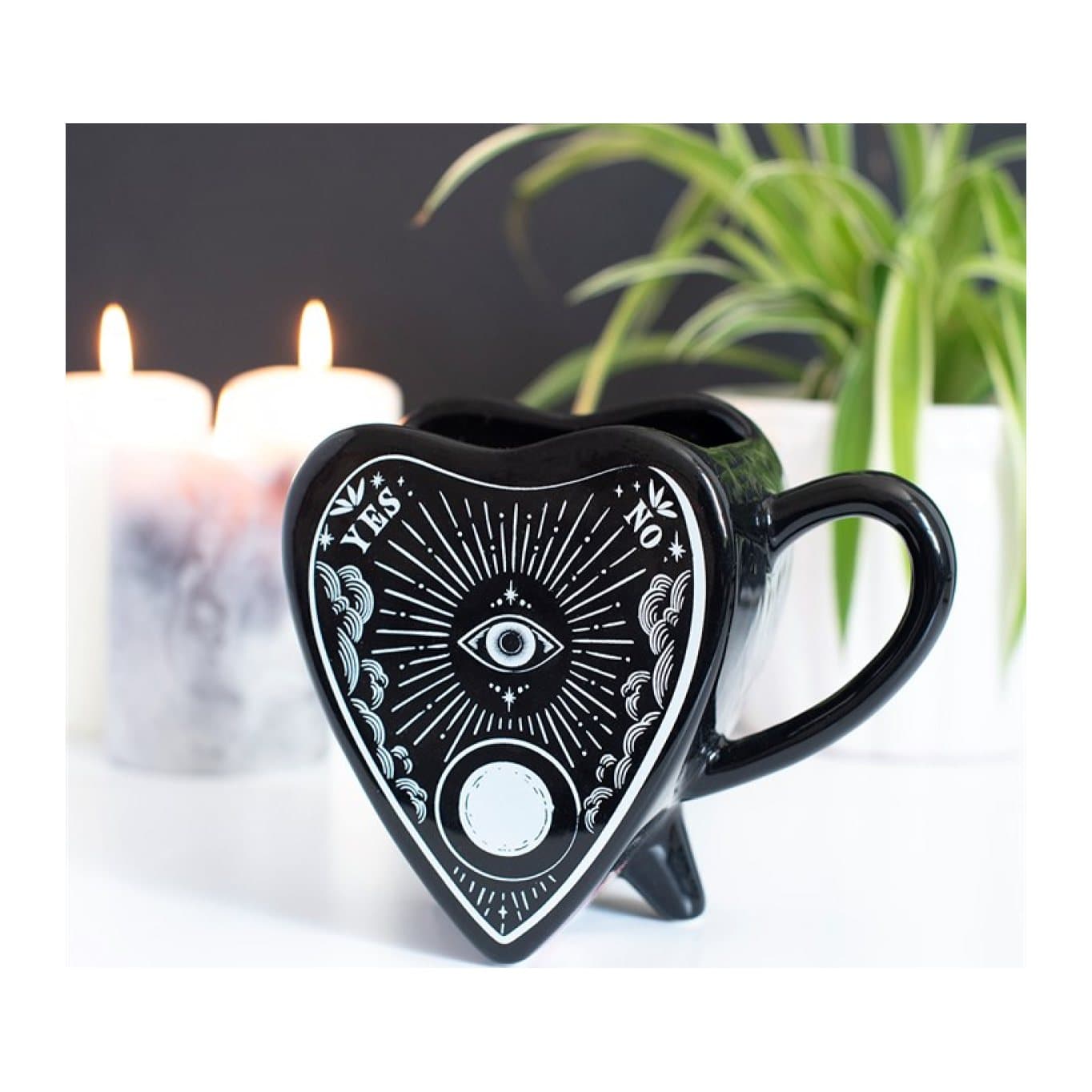 Black planchette-shaped ceramic mug with eye and moon details