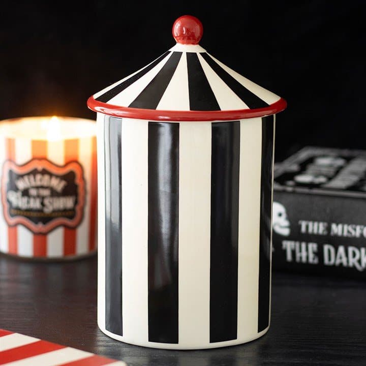 Ceramic storage jar with black stripes and a pointed circus tent lid