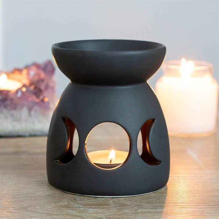 Black ceramic oil burner with a cutout triple moon design and matt finish
