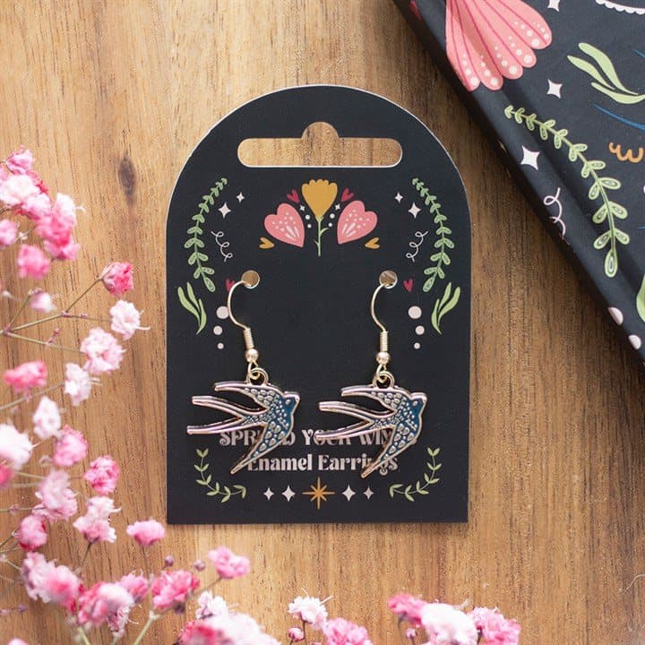 Blue swallow earrings on a cardboard back