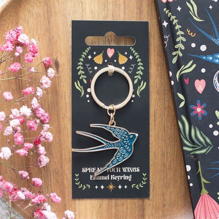 Blue enamel swallow keyring on a cardboard backing