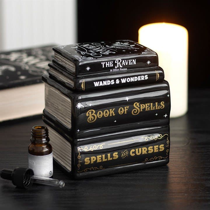 Ceramic oil burner shaped like a stack of spell books