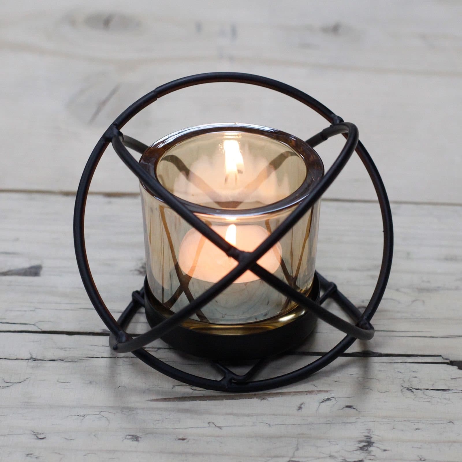 Iron votive candle holder with a glass cup