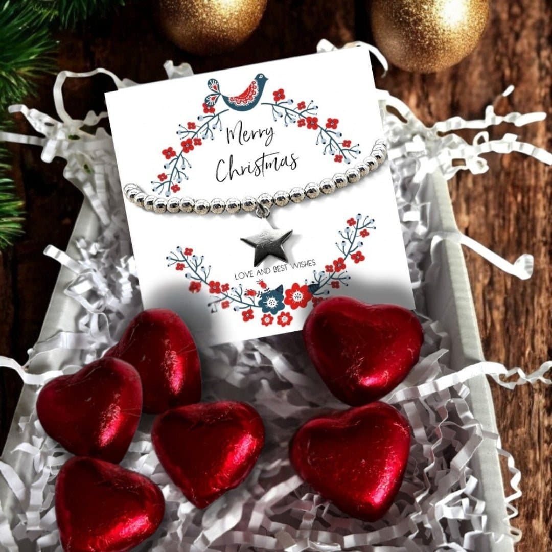 Christmas star gift box with a silver beaded star bracelet and red foiled chocolate hearts
