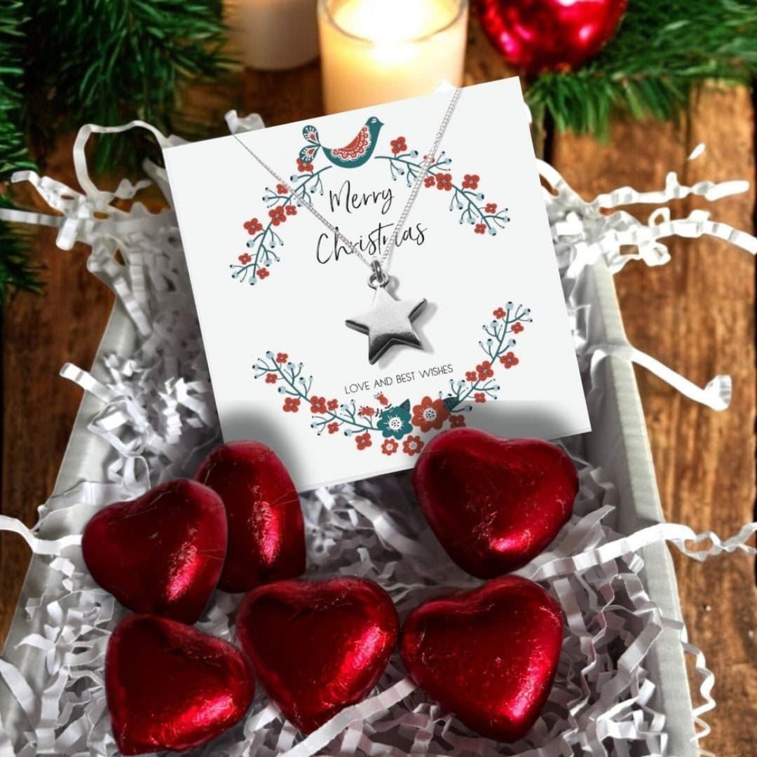 Christmas gift box with a silver star necklace and red foiled milk chocolate hearts