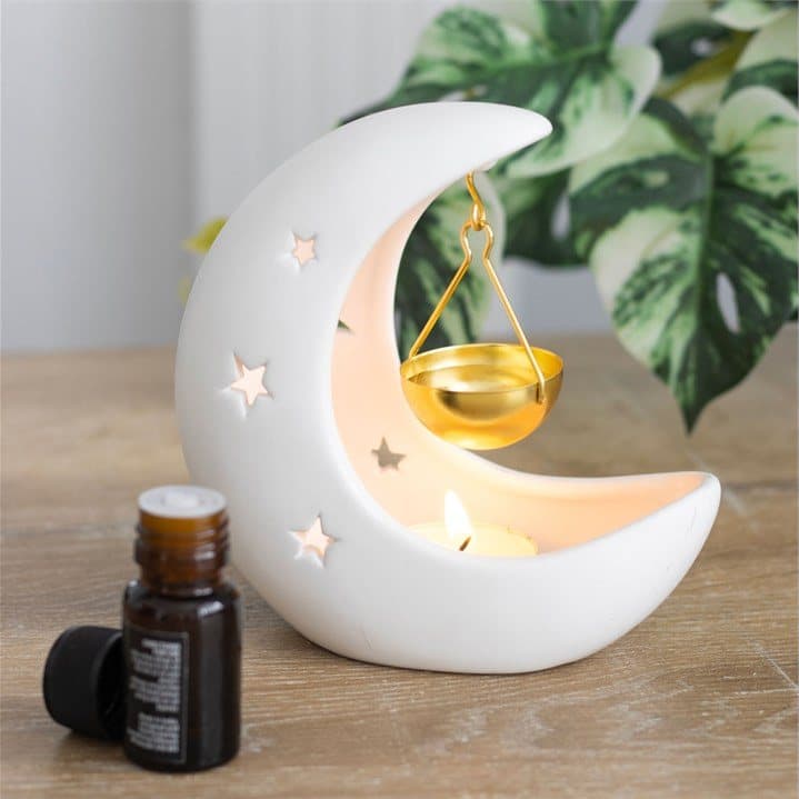 White crescent moon oil burner with a gold dish