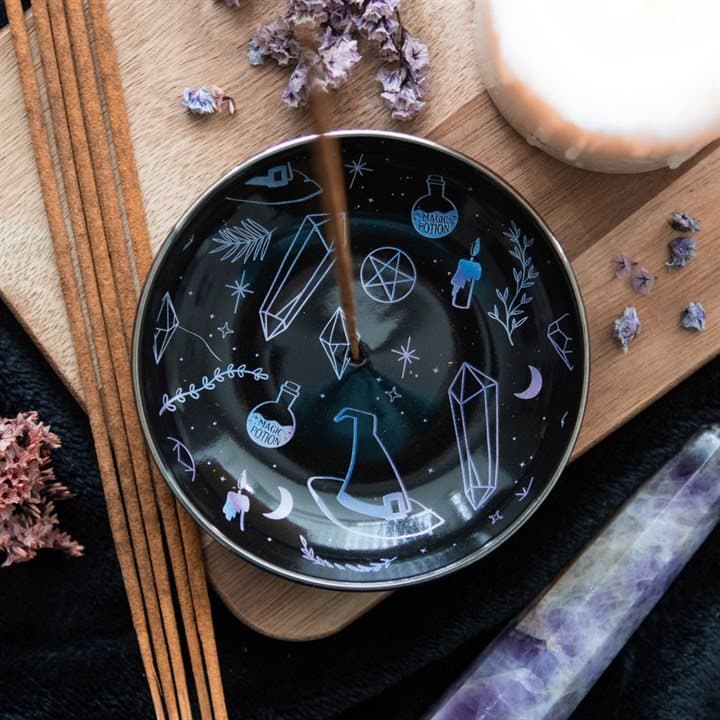 Black ceramic incense holder plate decorated with crystals, witch hats and potions