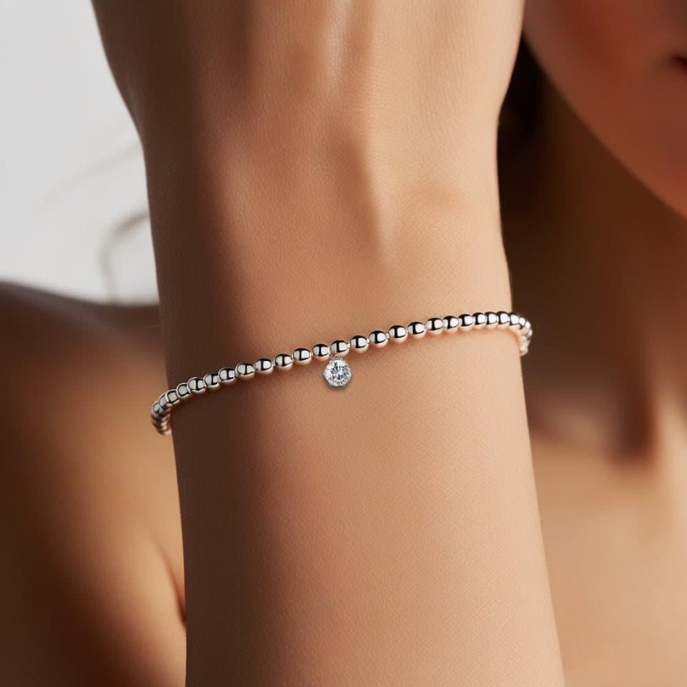 Silver beaded stretch bracelet with a cubic zirconia charm