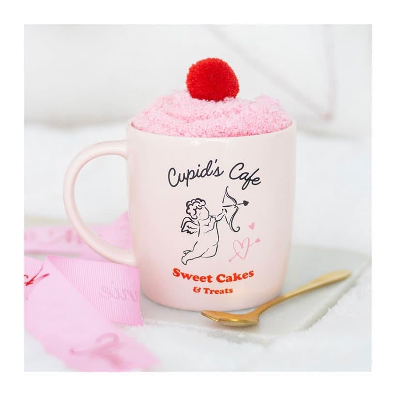 Pink Cupid's Cafe mug with a spoon and socks