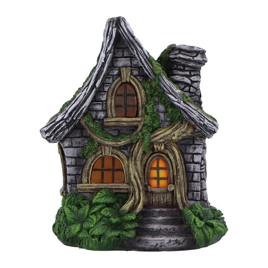 Curly Oak Manor fairy cottage with glowing windows, curved roof and stone chimney