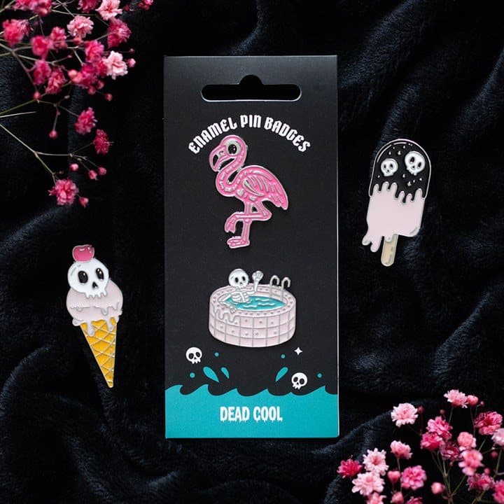 Enamel pin badge set with a skeleton and a flamingo design on a cardboard back