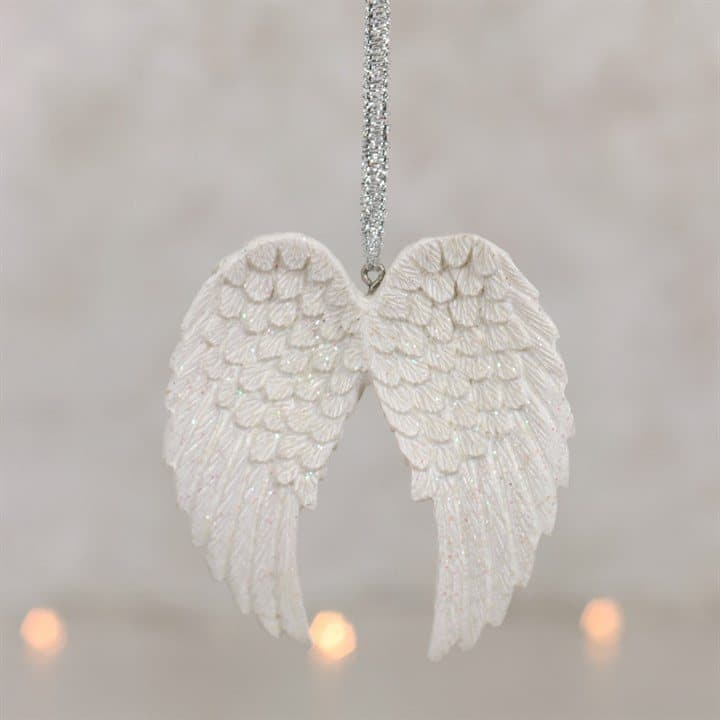 White double glitter angel wing hanging on a metallic silver ribbon