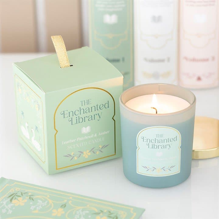 Green illustrated Enchanted Library jar candle with a gold lid