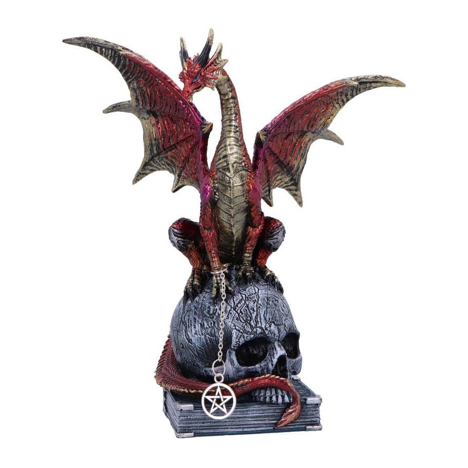 Red dragonling with gold accents perched on a skull figurine