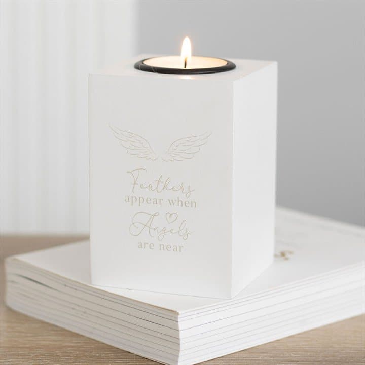 White angel wing tealight holder with the words Feathers appear when angels are near